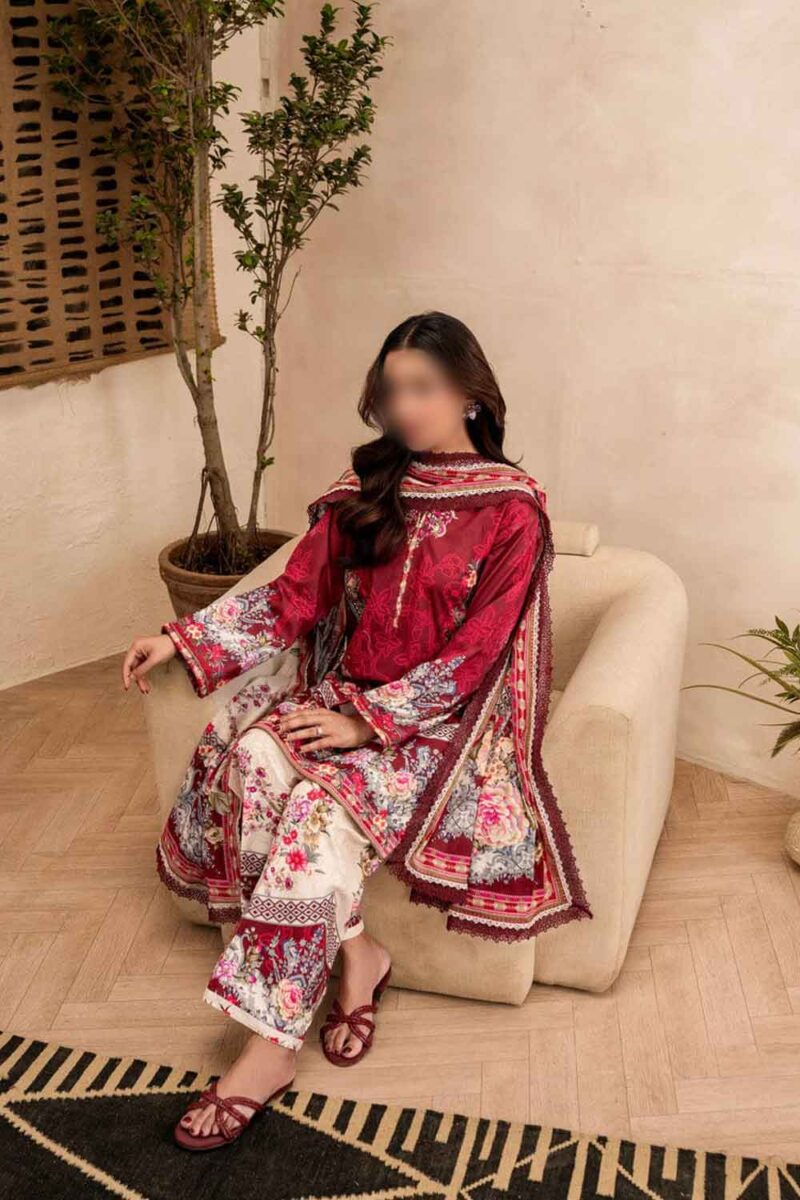 Full view of a woman wearing Firdous Printed Lawn 3 Piece Suit sitting gracefully on a sofa, showcasing deep purple printed lawn fabric and printed voile dupatta